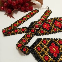 the beaded earrings are next to some berries