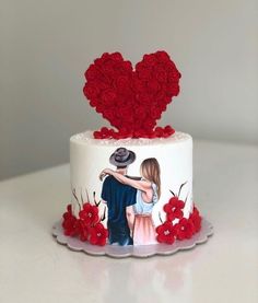 a wedding cake decorated with red roses and a painting of a couple on the top