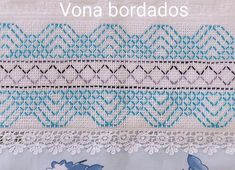 an embroidered piece with blue and white designs on it, along with the words'vona bordados '