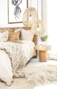 a bedroom with white walls and neutral bedding, rugs and lights hanging from the ceiling