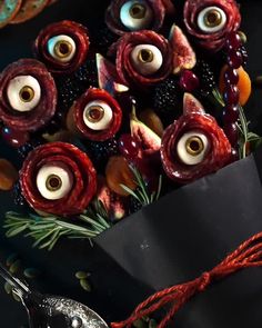 an arrangement of fake flowers with googly eyes on them for halloween decor or as decoration