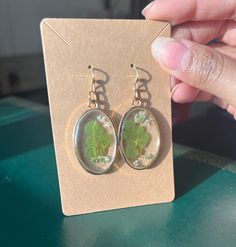 These simple, oval shaped earrings let you take a piece of nature wherever you go! featuring real plants and delicate queen anne's lace encased in UV resin, which is resistant to yellowing, lightweight, and preserves the plants' color long term. With a simple design, these earrings are a perfect addition to any everyday look 🌿 Nature-inspired Green Earrings With Pressed Flowers, Green Oval Hypoallergenic Earrings, Hypoallergenic Green Oval Earrings, Queen Anne's Lace, Queen Annes Lace, Oval Earring, Real Plants, Baby's Breath, Resin Earrings