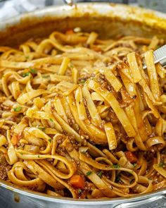 a large pot filled with pasta and meat