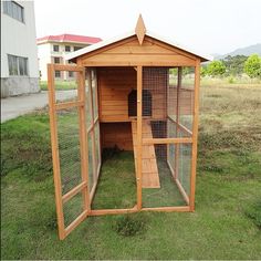 a small wooden chicken coop in the grass