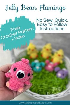 a hand holding a small pink crochet bear in front of some little chicks