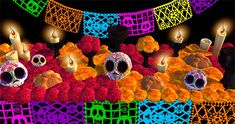 an artistic image of candles and flowers with skulls in the middle, surrounded by other decorations