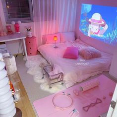 a bedroom with pink furniture and accessories on the floor in front of a flat screen tv