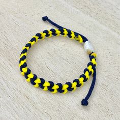 a yellow and black bracelet on a wooden table