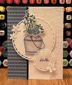 a close up of a greeting card with flowers in a pot on the front and side