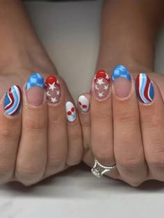 two hands with patriotic nail designs on them