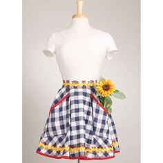 a mannequin wearing a dress with sunflowers on it