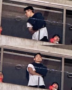 two people standing in the stands at a baseball game