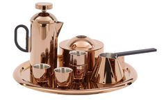 a copper colored coffee set with cups and saucers