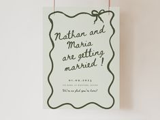 a wedding card with the words nathan and martha are getting married on it hanging from a hook