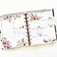 an open planner book with flowers on it