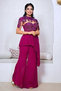 Wine peplum kurta with cutdana hand embroidered yoke and asymmetric hem. Paired with a plain sharara and cape with matching hand embroidery. - Aza Fashions Elegant Purple Georgette Sets, Elegant Purple Evening Sets, Elegant Purple Reception Sets, Sleeveless Purple Party Set, Elegant Sleeveless Set For Reception, Elegant Sleeveless Reception Set, Purple Sleeveless Wedding Set, Plain Sharara, Sharara Designs