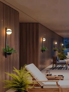 a living room filled with lots of furniture next to a wall mounted planter and potted plants