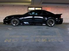 a black car parked in a parking garage