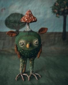 a green bird with a mushroom on its head