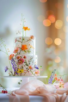 a three tiered cake with flowers on it