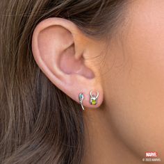 Ready to cause some mischief and chaos across the realms? Look no further than our Marvel's Loki Studs. Featuring a striking green silhouette of the God of Mischief in his signature horned helmet and holding his mystical scepter, complete with a vibrant blue accent. Get ready to channel your inner Loki and add a touch of rebellious style to your outfit with this one-of-a-kind set. Yelena Belova Ear Piercings, Yelena Belova Earrings, Loki Earrings, Loki Jewelry, Loki Scepter, Panther Earrings, Green Silhouette, Horned Helmet, Avengers Icon