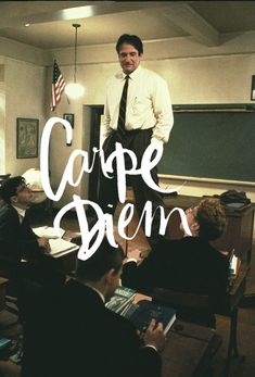 a man standing in front of a class room full of students with the words carpe dien written on it