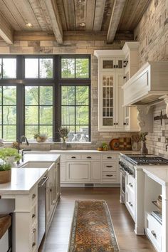 a large kitchen with white cabinets and wooden floors, along with an area rug on the floor