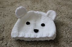 This is a polar bear hat that was knit from a pattern book by Fiona Goble.  It will fit a 6 month old.  The yarn I used is a medium weight acrylic that is machine washable.  The eyes and nose are cut from felt and sewn on. Polar Bear Hat, Family Stockings, Gingerbread Girl, Bear Hat, Christmas Socks, Baby Hat, Santa Christmas, Christmas Girl, Pattern Books