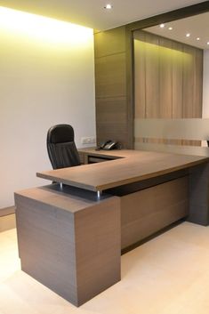 an office desk with a black chair in front of it