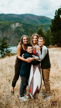 a family posing for a photo in the mountains