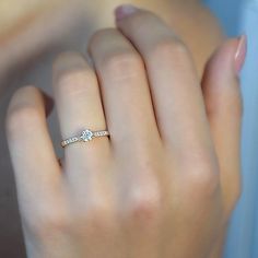 a woman's hand with a diamond ring on it