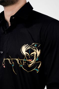 This Janmashtami, let your style reflect your devotion. Infuse your wardrobe with divine elegance through the Jade Black Shree Krishna Hand Painted Premium Cotton Designer Shirt. Meticulously hand-painted, it portrays the ethereal image of Lord Krishna serenading souls with his mystical flute. Experience the sacred artistry and unmatched comfort of this shirt, a reverent homage to spirituality and style. Fused collar and cuffs, collar stand and flat felled side seams provide structure and stabil T Shirt Design Hand Painted, Fabric Paint On Shirts Ideas, Black Fabric Painting, Hand Painted Shirts For Men, Black T Shirt Painting Ideas, Hand Painted Kurta For Men, Krishna Fabric Painting, Hand Painted Shirts, T Shirt Painting Ideas