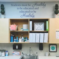 a kitchen sink under a sign that says students must be healthy to be educated and dedicated to be healthy