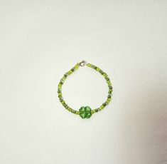 This bracelet features green glass beads and a Lucite shamrock as the center bead.  A great piece for St. Patty's Day or any day!  The wire and clasp are nickel.       The bracelet measures 7 1/2 inches long. Please Note:  This bracelet can be made shorter upon request. Nickel-free Green Beaded Bracelets As A Gift, Nickel-free Green Beaded Bracelets For Gift, Green Nickel-free Beaded Bracelets As A Gift, Nickel-free Green Beaded Bracelet For Gift, Green Heart Beads Bracelet Jewelry, Green Heart Beads Bracelet, Green Beaded Bracelets With Czech Glass, Green Nickel Free Bracelets With Round Beads, Green Beaded Czech Glass Bracelets