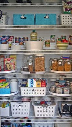 an organized pantry with lots of food and containers on the shelves, including plastic bins