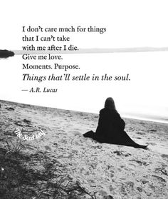 a woman sitting on top of a beach next to the ocean with a quote about love