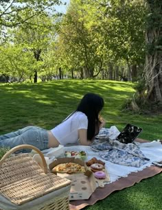 a woman is sitting on the grass and eating