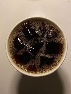 there is a cup of coffee with ice in it