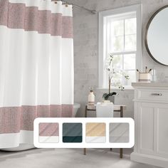 a bathroom with a shower curtain, toilet and sink in it's center area