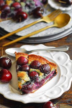 a piece of pie on a plate with cherries