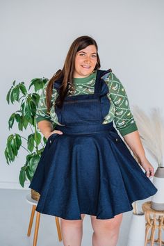 This rockabilly pinafore is crafted in dark blue denim and features button adjustable straps with a ruffled accent. Complete with a back zipper and functional side and chest pockets. Sizing:S =4 M= 6-8 L = 10-12 XL = 14 1XL = 16 2XL = 18 3XL = 20 4XL = 22-24 5XL = 26 Fit: True to Size Jo is 5’3” and wears size 14W/Misses 16 and is wearing 1XL Hannah (Dark Brown Hair) is 6' and wears a size 22W and is wearing 3XL Material: 59% Cotton, 35% Polyester, 6% Spandex Care: Hand Wash, Flat Dry Brand: Uni Blue Pinafore Dress, Blue A Line Dress, Pinny Dress, Plunging Neckline Dress, Plunging Neck Dress, Denim Pinafore Dress, Denim Pinafore, Pleated Denim, Blue Denim Dress