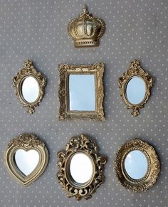 there are five mirrors and two crowns on the wall