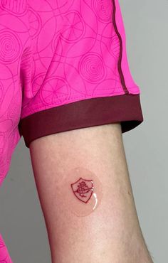 a person with a small tattoo on their arm and the bottom half of her leg