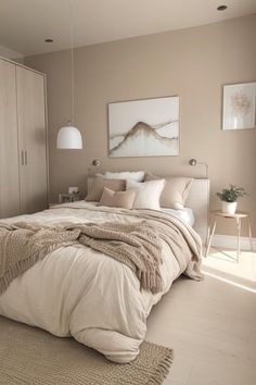 a bedroom with a large bed and beige walls