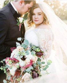 a bride and groom pose for a wedding photo