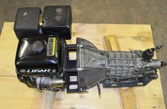 the front end of an electric vehicle on a wooden pallet with two remote controls