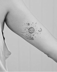 a black and white photo of a woman's arm with a tattoo on it