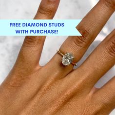 a woman's hand with a diamond ring on it and the words free diamond studs with purchase