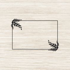 a wooden background with a black frame and some leaves on the border, as well as an empty space for text