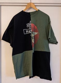 a black and green shirt hanging on a wall